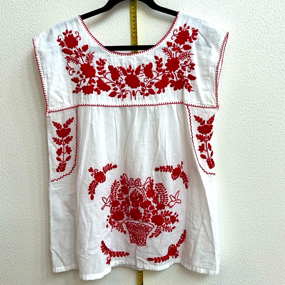 Cool Mexican blouse that’s red and white with stitched flowers and classic style